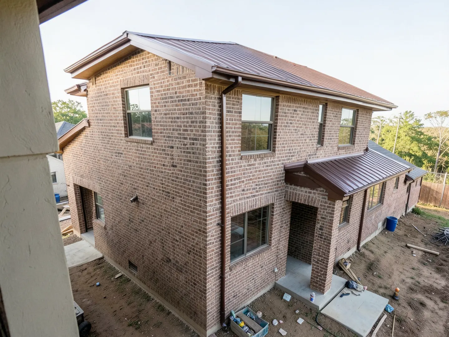 Finished seamless gutter installation on a multi-gable brick home in Cinco Ranch