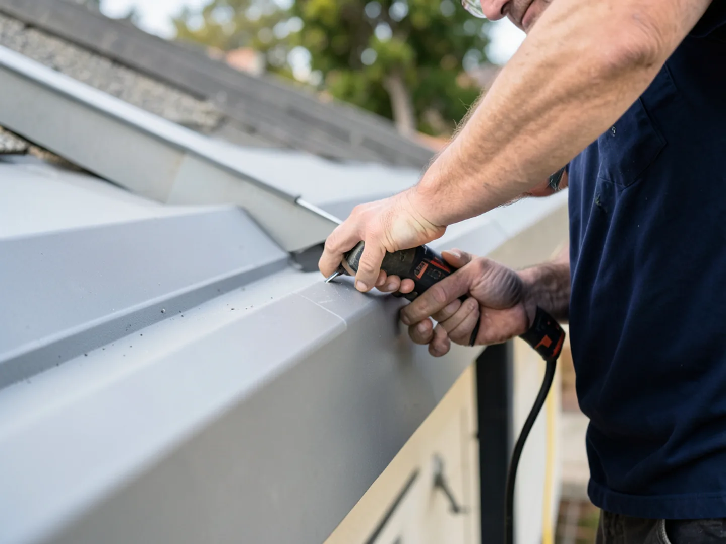 Installer securing heavy-duty internal hangers along straight gutter run in Rosenberg